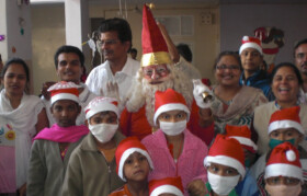 Children posing with Santa. Santa gave gifts, chocolates, goodies and loads of love
