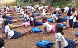 School kids doing yoga. 