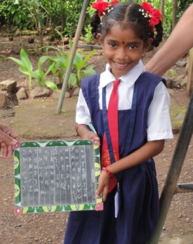 Girl from Nandelpada showing her work - They are very comfortable with spellings of three letter words now. 