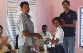 Children being felicitated in presence of their parents by local Sarpanch and other leaders
