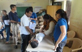 Teacher helping team for administering tetanus injection
