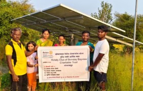 Farmers proudly standing in front of installation