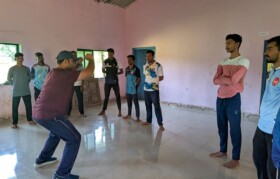 Trainer giving guidance for muscle strengthening exercise to Janathepada boys